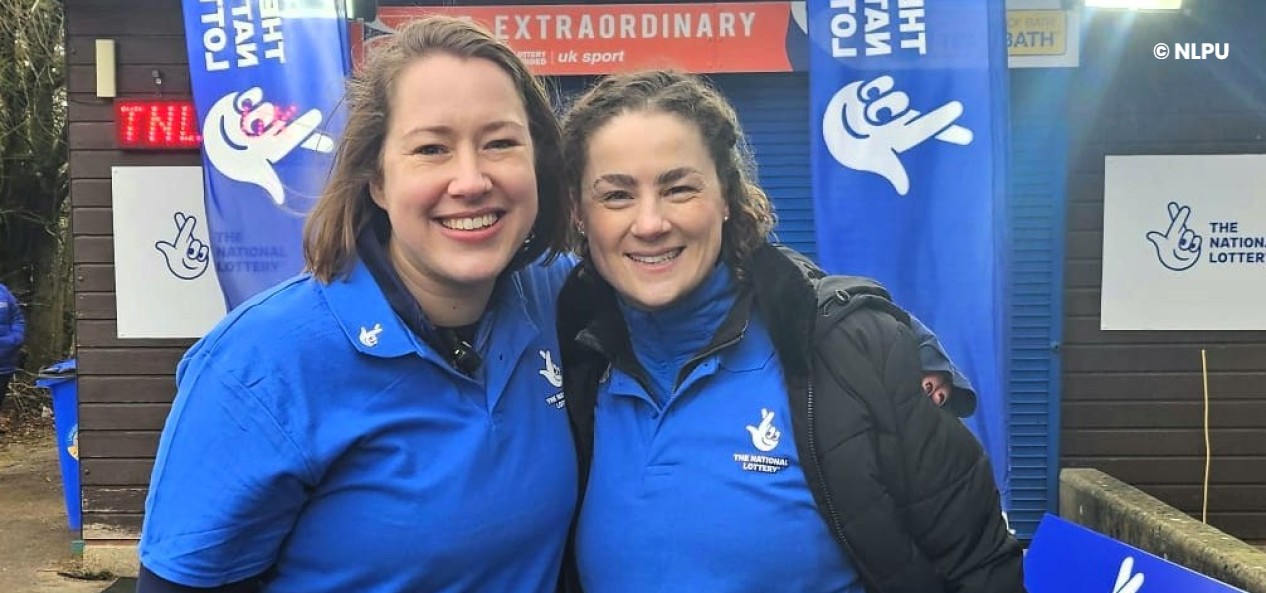 Former Team GB skeleton athletes Lizzy Yarnold and Laura Deas pose for a photo wearing National Lottery shirts.