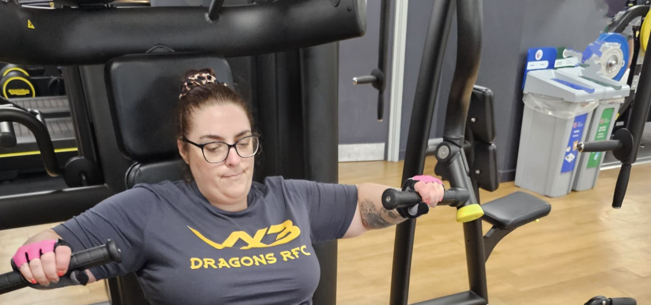 Woman using machine at gym