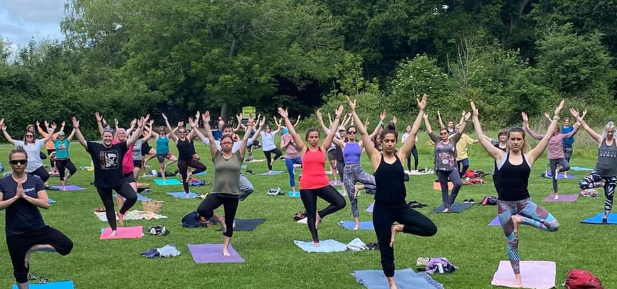 People doing yoga in a park