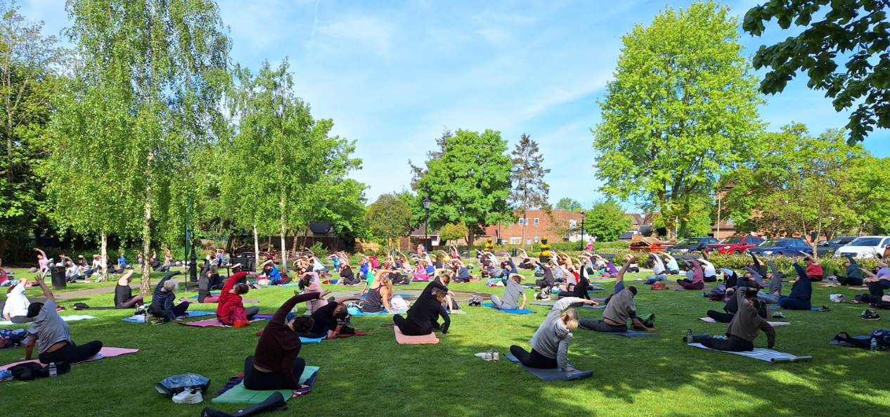 People doing yoga in a park