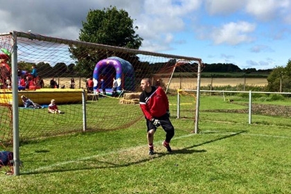 A man plays football at Forest Hall Young People’s Club in North Tyneside 