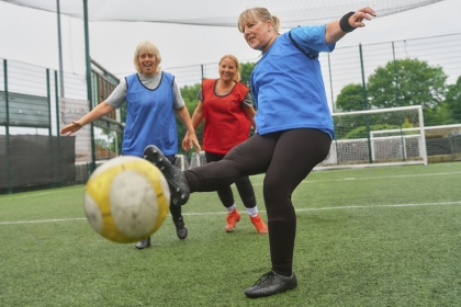 A group of older women play walking football