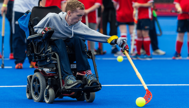 Boy in wheelchair playing hockey