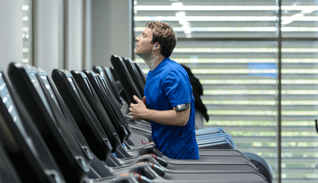 Man running on treadmill in gym