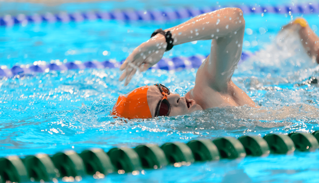 Man swimming in London Aquatics Centre
