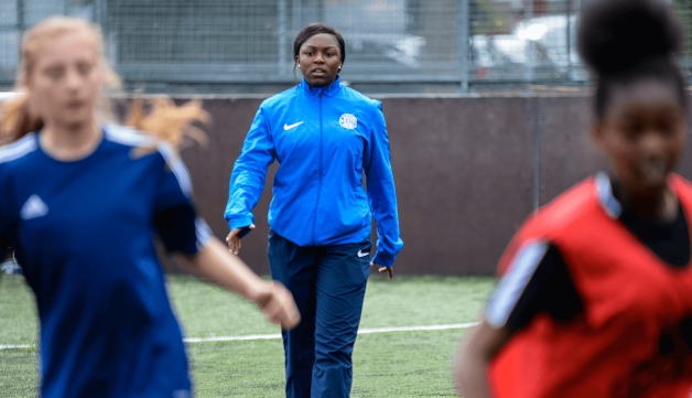 Volunteering football coaching facing camera