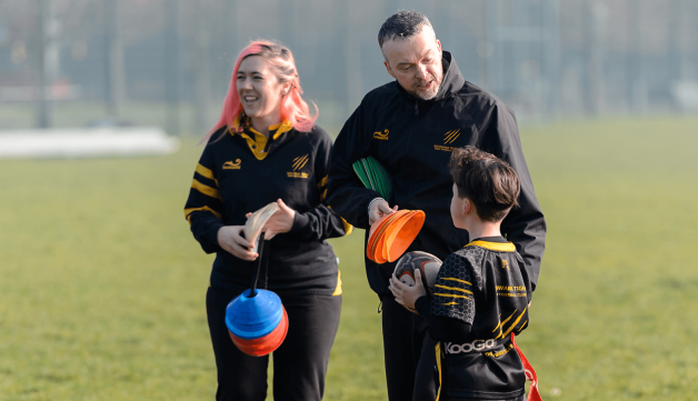 Volunteering rugby coaches helping out