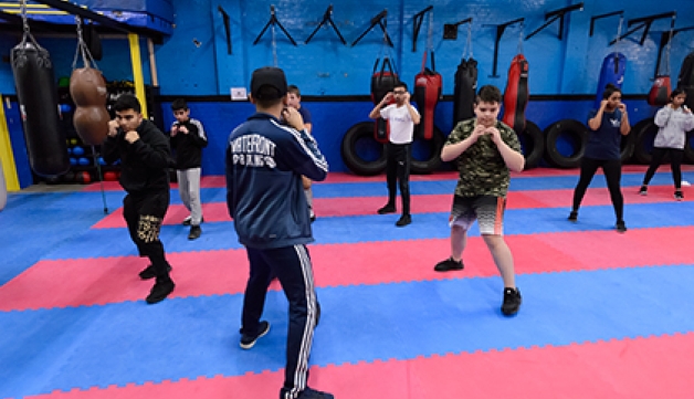 A group of young boxers warming up inside Waterfront Boxing Academy.