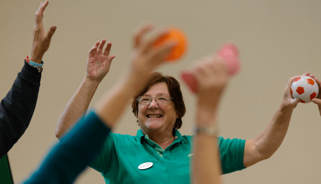 Exercise class with their arms in the air