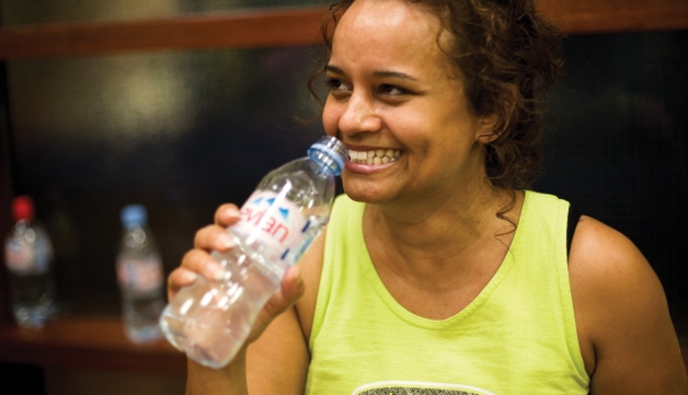 Aerobics woman drinking water whilst laughing
