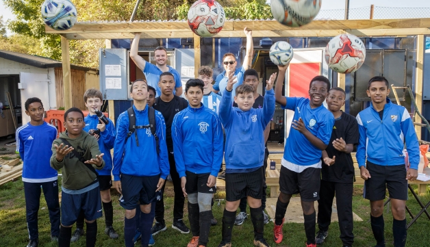 group of young boys throwing footballs