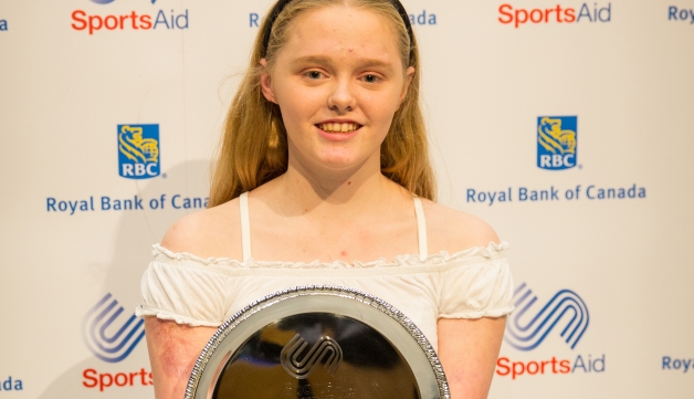 girl holding award
