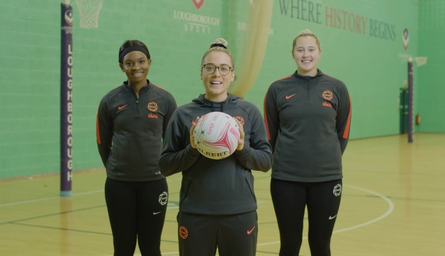 three women on a netball court