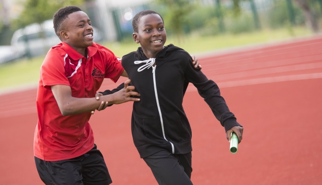 Two boys running a relay