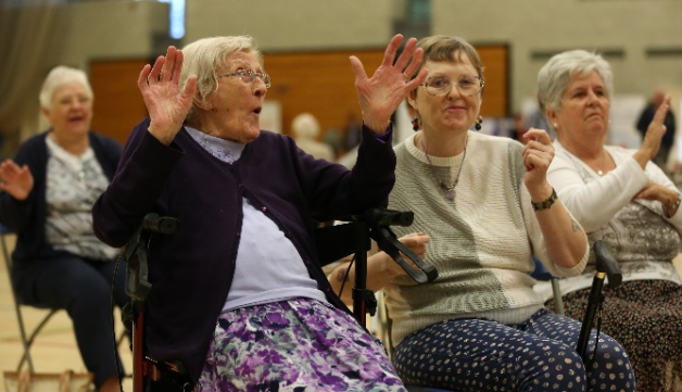 elderly women exercising in a sports hall