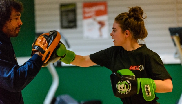 girl boxing with a coach