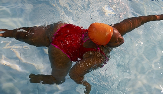 An overhead shot of Glynis swimming in a pool.