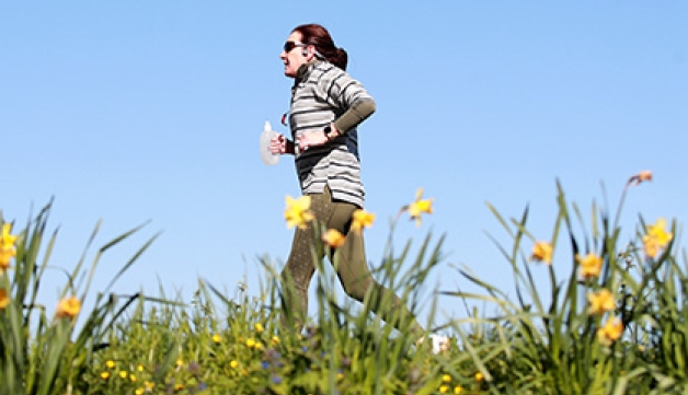 A runner jogs through the park