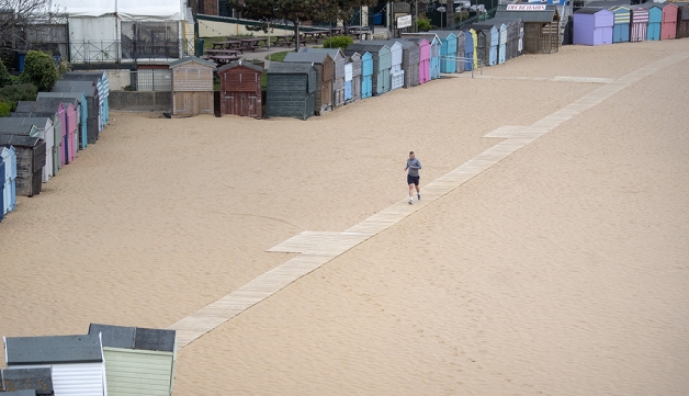 A man runs alone on Broadstairs beach, Kent