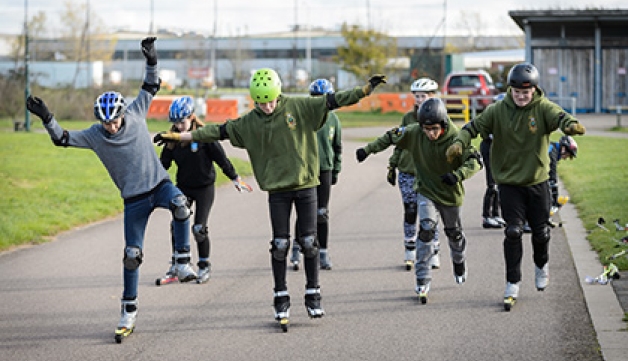 Teenagers try out Nordic skiing, on roller skis