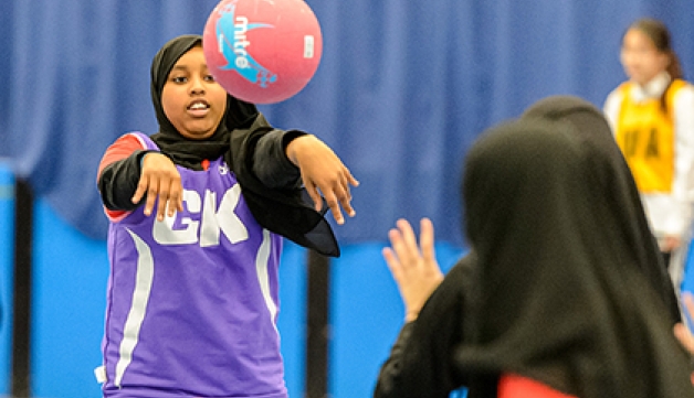 A girl playing netball