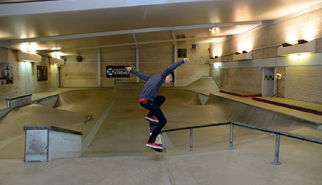 A boy skates in in a swimming pool that's been converted into a skate park