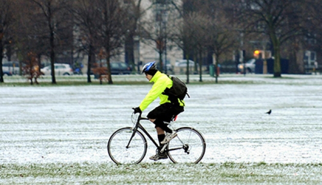 A man cycles in the snow