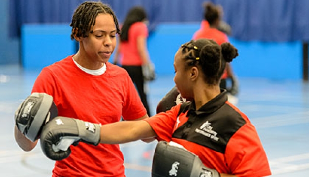Two school children in a boxing drill during a school PE lesson