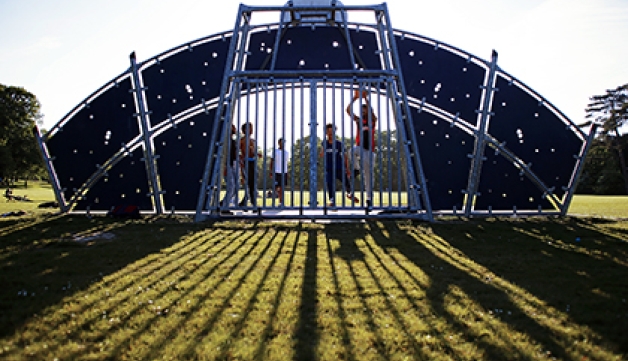 Teenage boys play basketball in a park