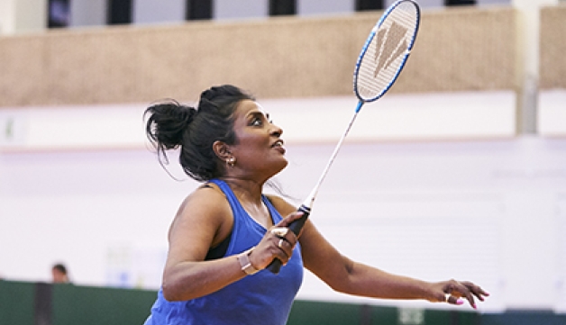 A woman playing badminton