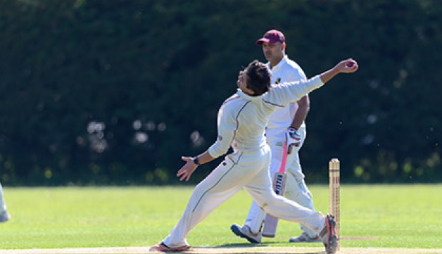 A man bowls the ball during a local league cricket match