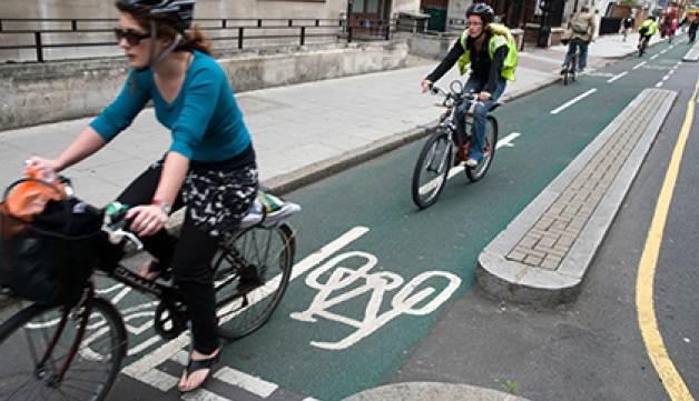 Cyclists ride on a segregated bike lane in London.