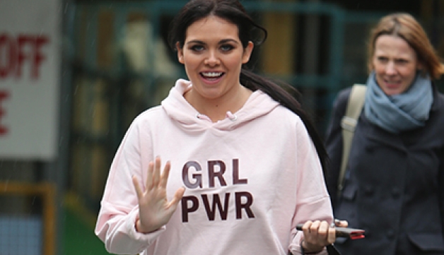 Former Gogglebox star Scarlett Moffatt waves at the camera, wearing a hoodie with 'GRL PWR' on it.