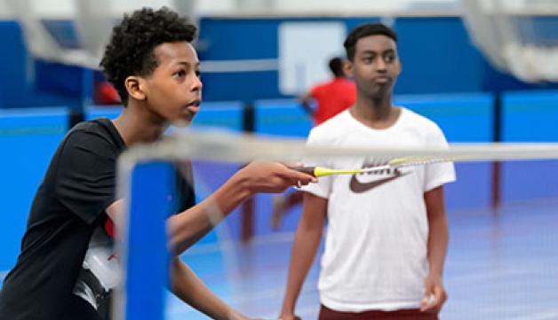 Two boys playing badminton