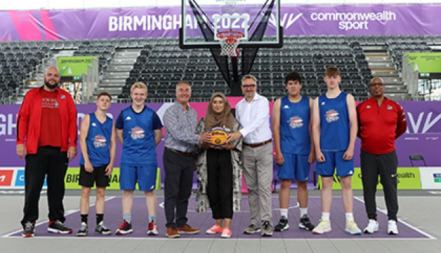 Sport England CEO Tim Hollingsworth poses on the 3x3 basketball court at Birmingham 2022 with a representatives of Basketball England, Birmingham City Councul and local basketball players