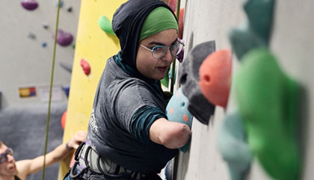 A woman using a climbing wall 