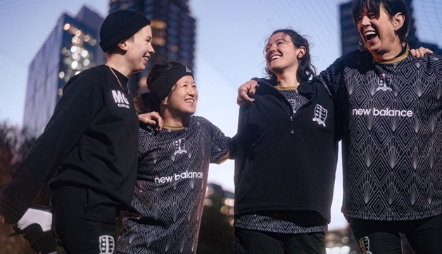 A group of women hold a team talk in a football match