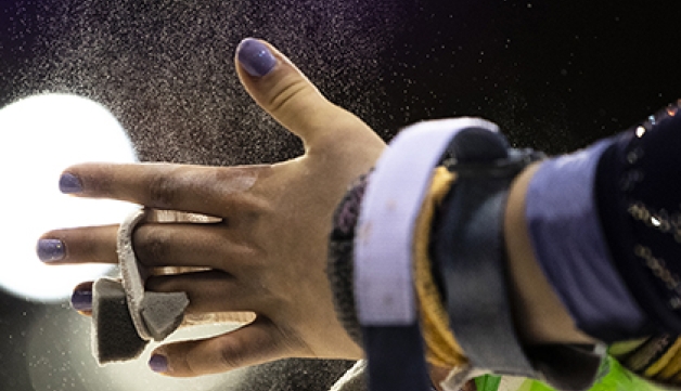 A gymnastic adjusts a wrist guard