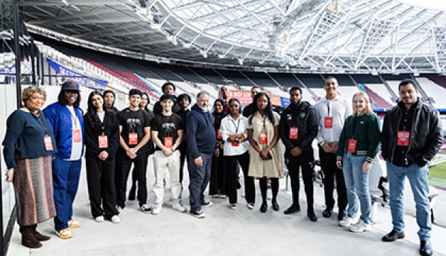 Winners and judges of the Go! London Young Entrepreneurs competition pose for a photo at London Stadium