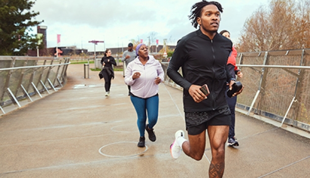 A group of people, run in a park