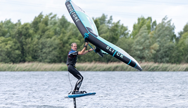 A man kite surfs on a lake