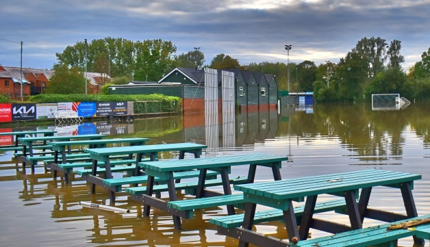 Picnic benches in water at Stony Stratford Cricket Club after flooding in September 2024.