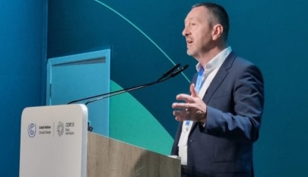 Chris Boardman speaks at a lectern during COP29 in Azerbaijan.