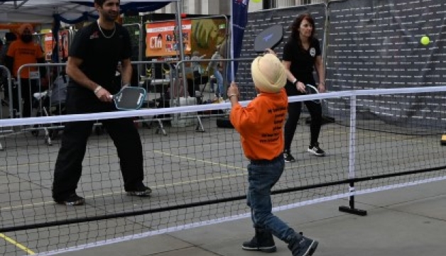 Adults and youngsters play pickleball at a pop-up Pickleball England stall during the Sikh Games in Trafalgar Square, London.