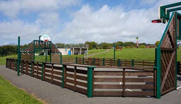 Games court for football, basketball or hockey within a community playground.
