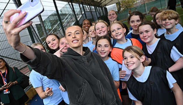 England footballer Chloe Kelly takes a selfie with a groups of girls at an after-school football club