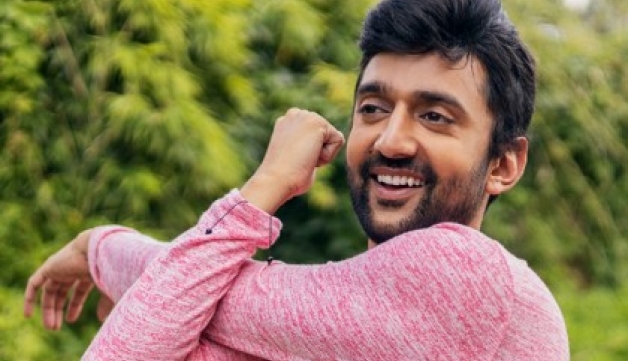 A man stretches his arm across his body ahead of an outdoor yoga session.