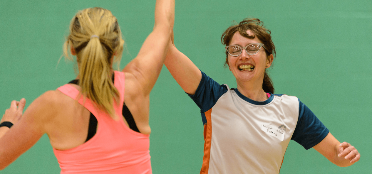 Two women high fiving during game
