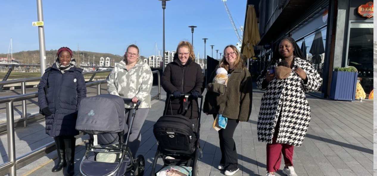 Group of mums on a walk with their babies in pushchairs