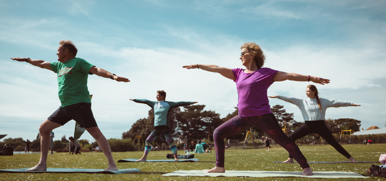 People doing yoga in a park